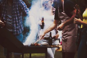 Friends camping and having a barbecue in forest